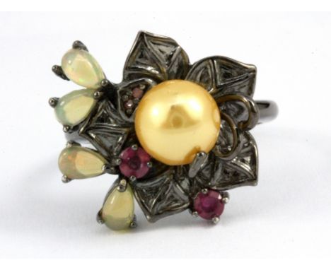 A 925 silver flower shaped ring set with opals, rubies and a cream pearl, (P).