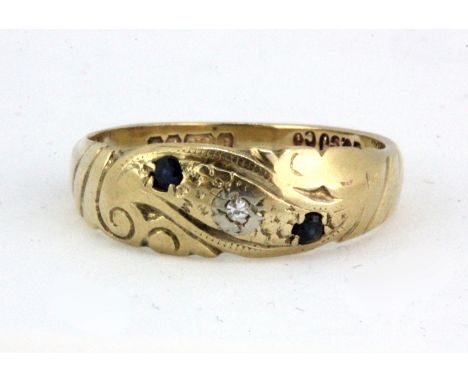 A 9ct yellow gold ring set with sapphires and a diamond, (K).