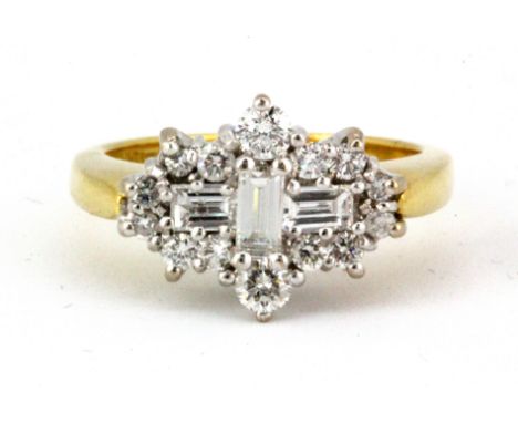 An 18ct yellow gold cluster ring set with baguette and brilliant cut diamonds, (K.5).