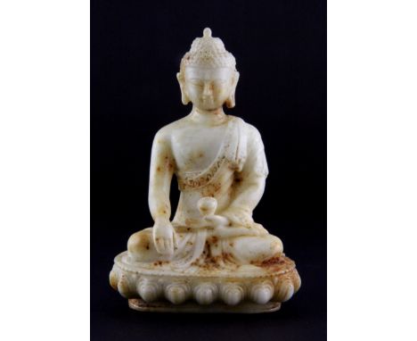 A Chinese carved jade/hardstone figure of the seated Buddha, H. 11.5cm.