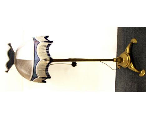 An Art Nouveau extending brass lamp and shade.