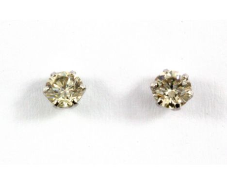 A pair of 900 platinum diamond set stud earrings, approx. 0.50ct overall, colour J-K, clarity VS.