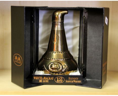 A boxed bottle of Whyte &amp; Mackay deluxe scotch whiskey.