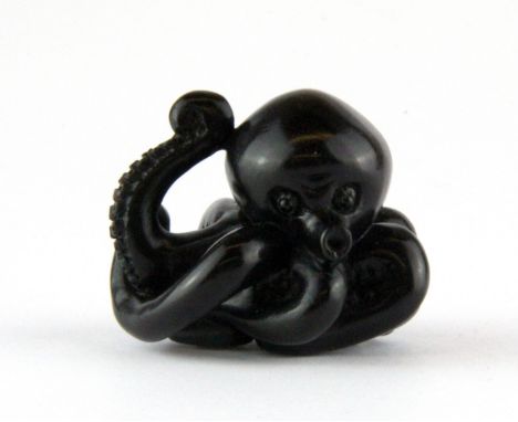 A Japanese signed and stained wooden netsuke of an octopus, H. 3.5cm.