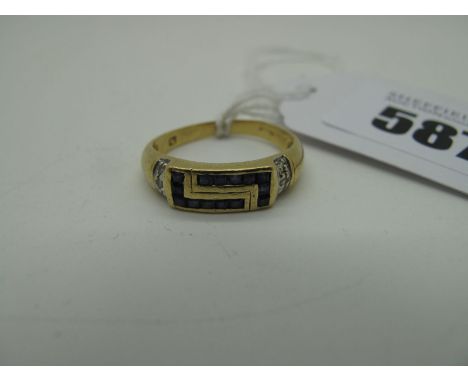 A Modern Inset Dress Ring, of Grecian style, between wide tapering shoulders (finger size N) (3.5grams). 