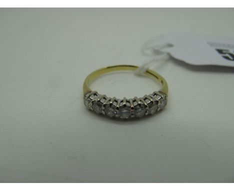 An 18ct Gold Seven Stone Diamond Ring, the brilliant cut stones claw set (finger size P) (2.6grams). 