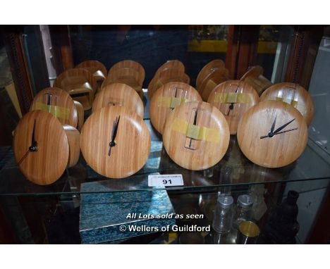 SHELF OF NINE BRAND NEW SMALL WOODEN WALL CLOCKS