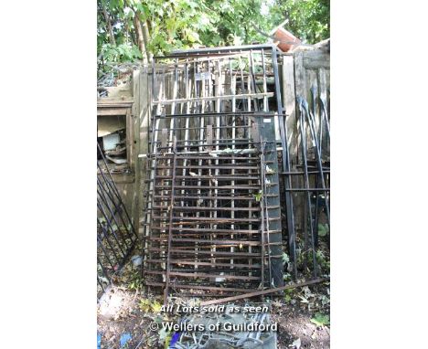 STACK OF EIGHT MIXED WROUGHT AND CAST IRON GATES AND RAILING SECTIONS