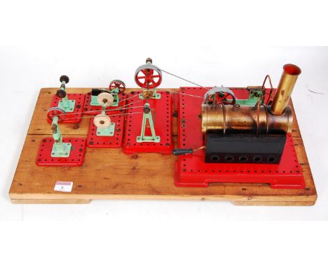 A Mamod stationary steam plant and workshop accessory set, comprising Mamod stationary steam plant with tin housed brass boil