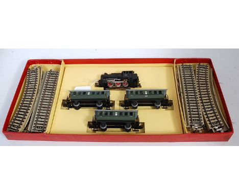 A Marklin H0 ref 3100 train set in red picture box, contains 0-6-0 tank engine, 3 green metal 4 wheel coaches, track oval, in