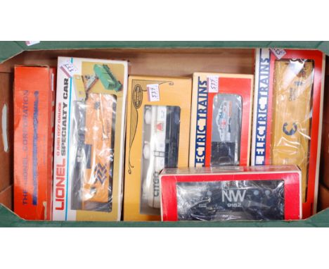 A large tray containing six boxed Lionel wagons including yellow C&amp;O chessie system ACF 3-bay hopper 6-17104, grey Lionel