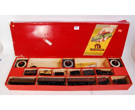 A Trix Twin Railway long red set box containing freelance LMS red 0-4-0 engine and tender No. 5670 (FG), 3 shorter bogie coac