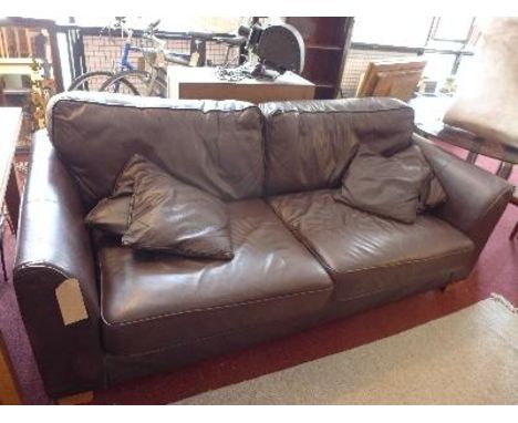 A contemporary brown leather three seater sofa, raised on bracket feet 