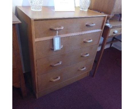 A mid 20th century G-plan light oak chest, with four drawers, raised on plinth base, H.85 W.76 D.46cm 