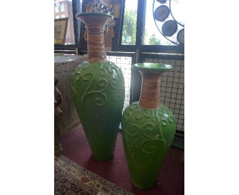 A green glazed ceramic Rumput vase, having swirling floral design and bamboo detailing to neck, H.100cm, together with a matc