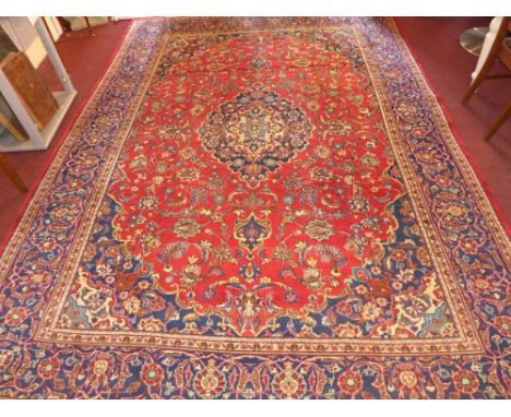 A fine Central Persian Kashan carpet, central double pendent medallion with repeating spandrels on a rouge field within styli