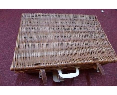 A vintage Brexton wicker picnic basket, containing two thermoses, two plastic food boxes, tea caddies, three cups, four spoon
