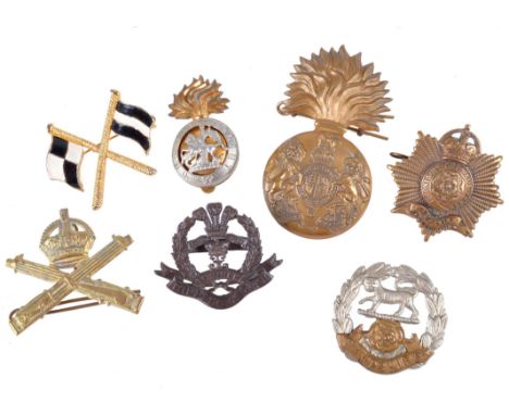 A small quantity of British insignia, including: a Lewis Gunner's fabric arm patch, the cap badges of various regiments, swag