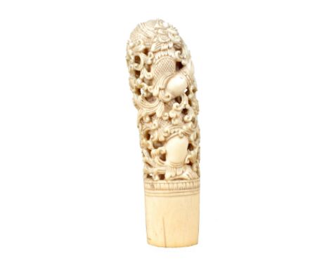 λ A Burmese carved ivory hilt, for a dha hmyaung (dagger), the upper part with intricate openwork carving representing a demo