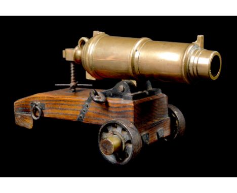 Ƒ An excellent working model of a British Naval carronade, 4 bore brass ordnance 11 in. long including breeching loop and ele