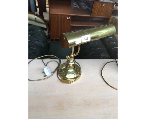 An adjustable brass desk lamp 