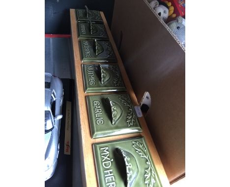 A spice rack with ceramic drawers 