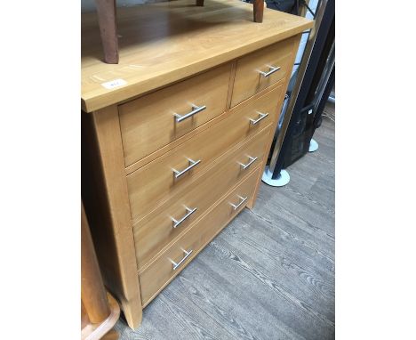 A modern light oak chest of drawers 