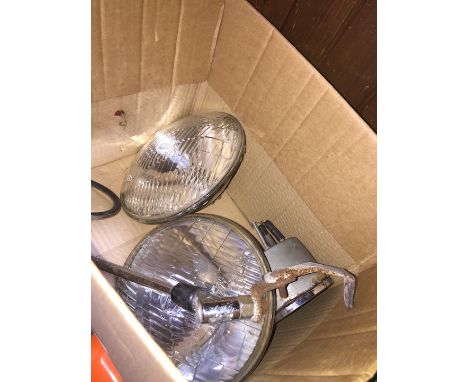 A box with Lucas car spotlights, wing mirror and a Smiths Rev counter 