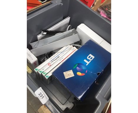 A box containing Wii console, games and 4 pack home telephones 