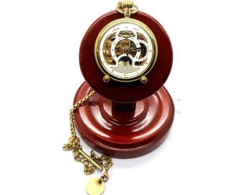 Modern gold plated skeleton pocket watch with chain on a wooden stand. P&amp;P Group 1 (£14+VAT for the first lot and £1+VAT 