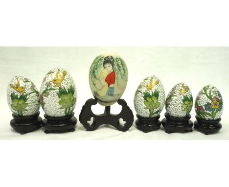 Hand painted Japanese turned stone egg and five enamel eggs, largest H: 70 mm including stand. P&amp;P Group 2 (£18+VAT for t