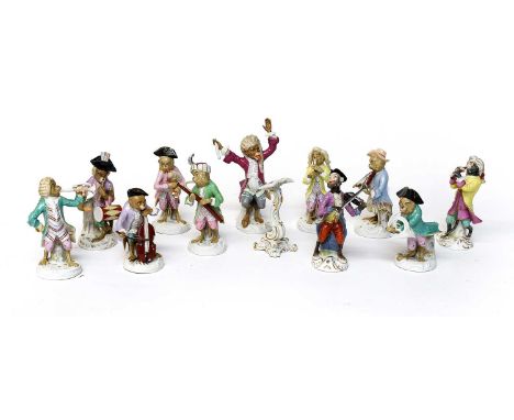 An Assembled German Porcelain Monkey Band, 19th / 20th century, after Meissen, comprising eleven players and a music stand, c