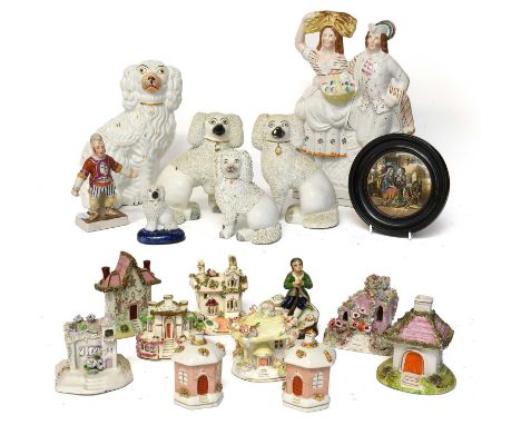 Nine Victorian Staffordshire Pottery Cottages, Pastille Burners and Money Boxes, coloured in enamels and ornamented with shre