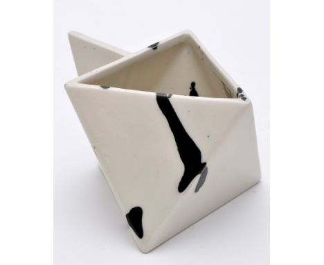 A modern ceramic cream jug, of diamond form, decorated with black 'splash' design, 7cms (2 3/4in.) high.