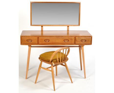 Ercol: a light stained elm dressing table, the rectangular mirror back above a top fitted three drawers to the frieze, raised