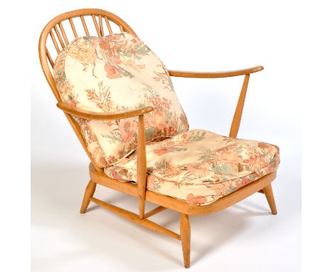 A low beech wood armchair, probably by Ercol, with spindle back.