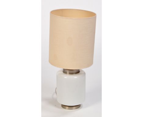 Manner of Harvey Guzzini, Italy: an opaque glass table lamp fitted chrome metal mounts and material shade, 59cms (23in.) high