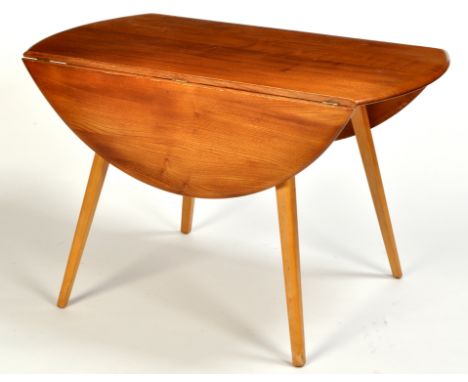 Ercol: an elm drop leaf dining table, the oval top on rounded square tapering legs, 112 x 120 x 71cms (44 x 47 x 28in.); toge