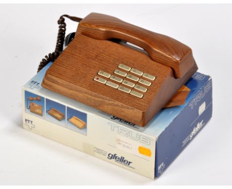 A Gfeller Trub telephone, c.1970's, in solid teak, complete with original box, handset cloth, instructions, etc.
