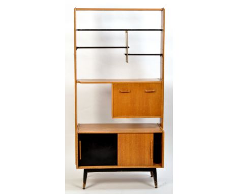 E. Gomme (G-Plan): an oak sitting room unit, the ebonised upper shelf with metal fitting below to take two further ebonised s