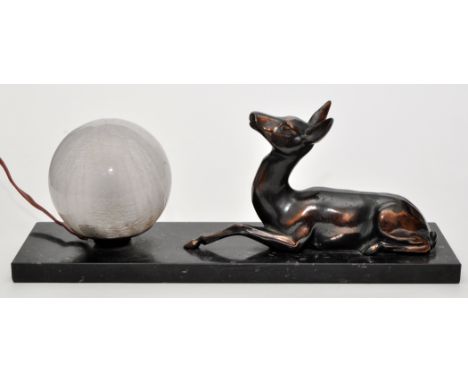 An Art Deco style table lamp with recumbent deer, raised on polished granite base, 35cms (13 3/4in.) high.