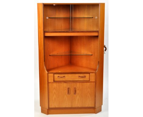 G-Plan: a teak corner unit, the glazed front enclosing a shelf, further shelving below, single drawer and cupboard doors unde