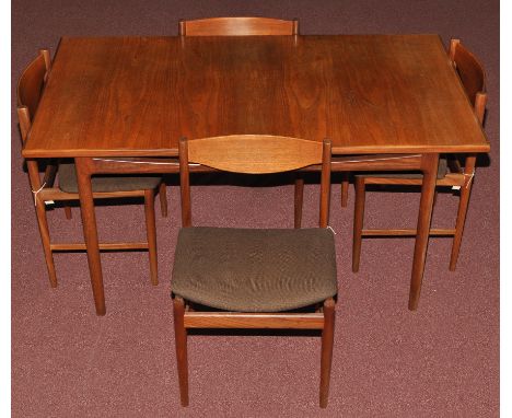 A teak extending dining table and four dining chairs, probably G-Plan, c.1960's, the rectangular table with two spare leaves,