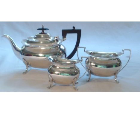 Three piece silver hallmarked tea service comprising footed teapot, milk jug and sugar bowl, marks for Walker & Hall Sheffiel