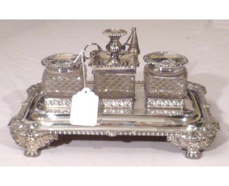 Large George IV silver desk set stand, rectangular gadrooned rim base with scallop & foliate corners and lion paw feet, suppo