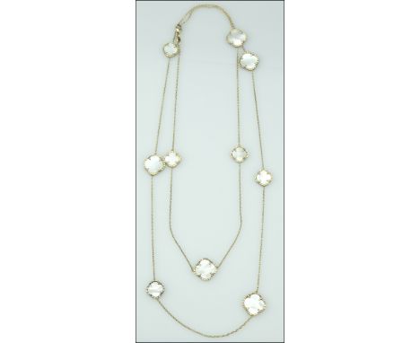 A silver gilt necklace and ear pendants suite, the belcher-link chain spaced by a series of mother-of-pearl quatrefoil panels