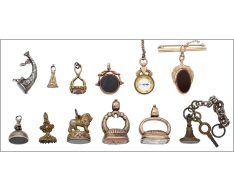 A collection of 19th century and later fob seals, comprising assorted gold and gilt metal mounted agate and paste seals, incl
