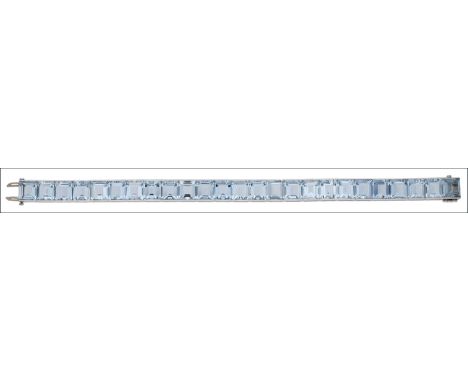 An aquamarine line bracelet by Cartier, circa 1940, channel set with a row of 25 step-cut aquamarines, mounted in platinum, s
