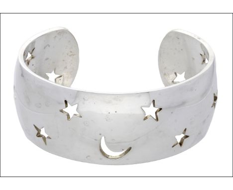 A silver constellation cuff bangle by Hermès, with pierced star and crescent moon decoration, signed ‘HERMÈS’ and stamped ‘92