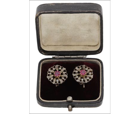 A pair of ruby and diamond cluster earrings, circa 1890, each set with a circular-cut ruby within a pierced cluster surround 